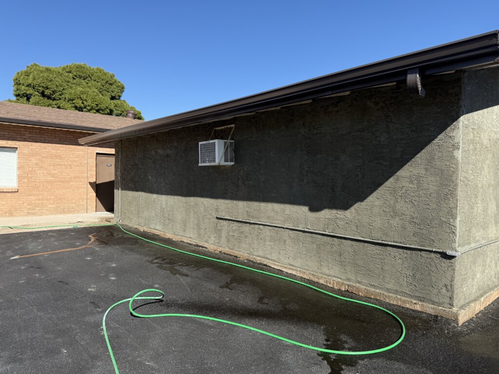 The back side of a building in Tucson with freshly applied stucco are a stucco repair has been complete